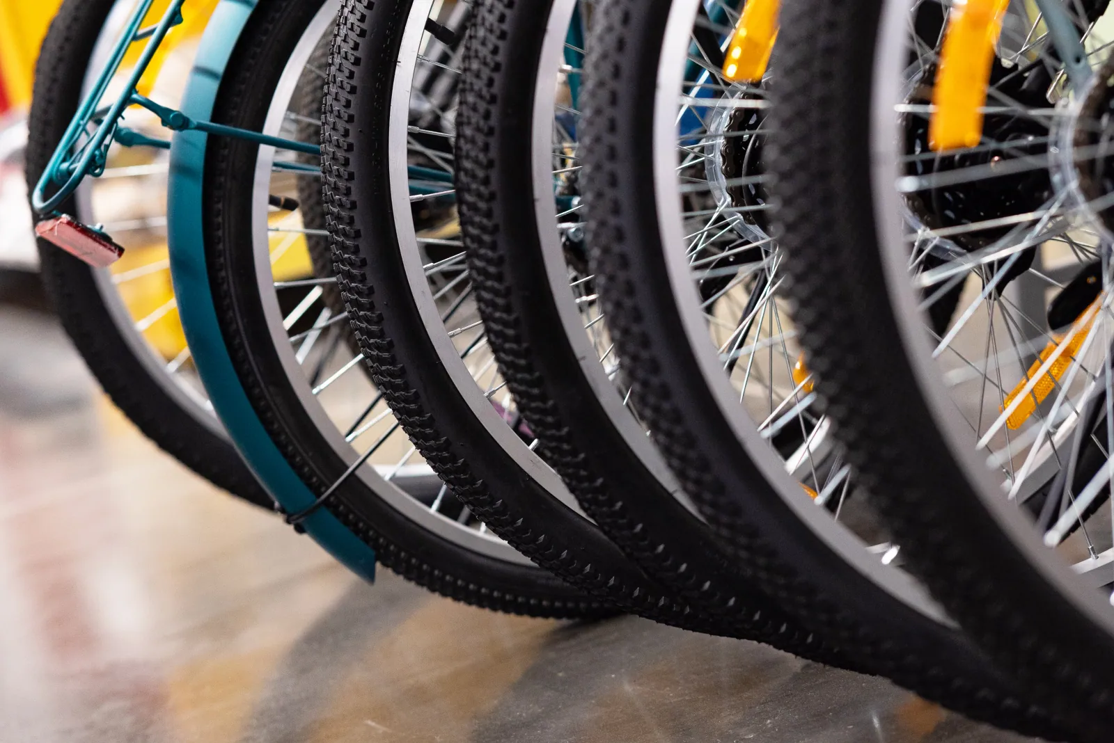 Bicycle wheelset and tires on a workshop bench, the visual signature for a service-focused wheel and tire supplier