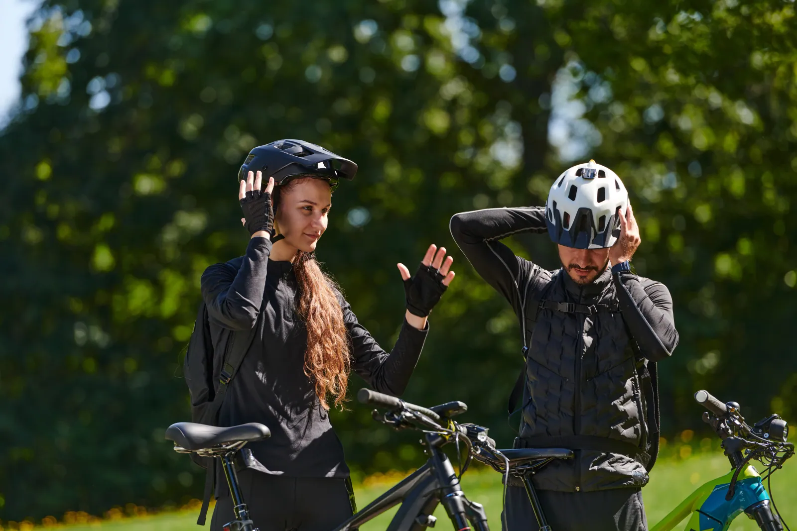 Trail and downhill knee pads, an elbow pad, a hip protector and a back protector arranged on a workshop bench to show impact-tier variety