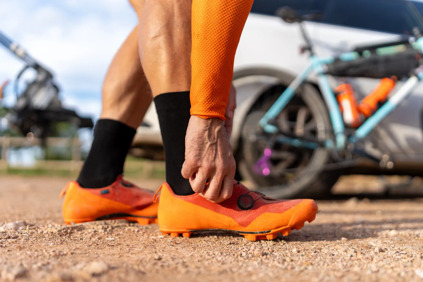 Road, MTB, gravel, commuter and flat-pedal cycling shoes arranged on a workshop bench to show the cleat ecosystems at a glance